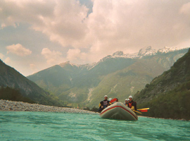 Rafting in river Soca surrounded by Julian Alps